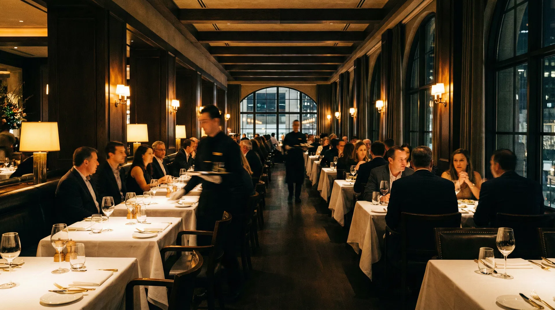 Elegant full-service restaurant at dinner service with waitstaff and guests